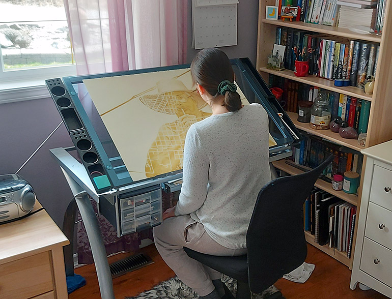 BFA student Stephanie Tennert works in her home studio on a drawing in preparation for the year end exhibition.