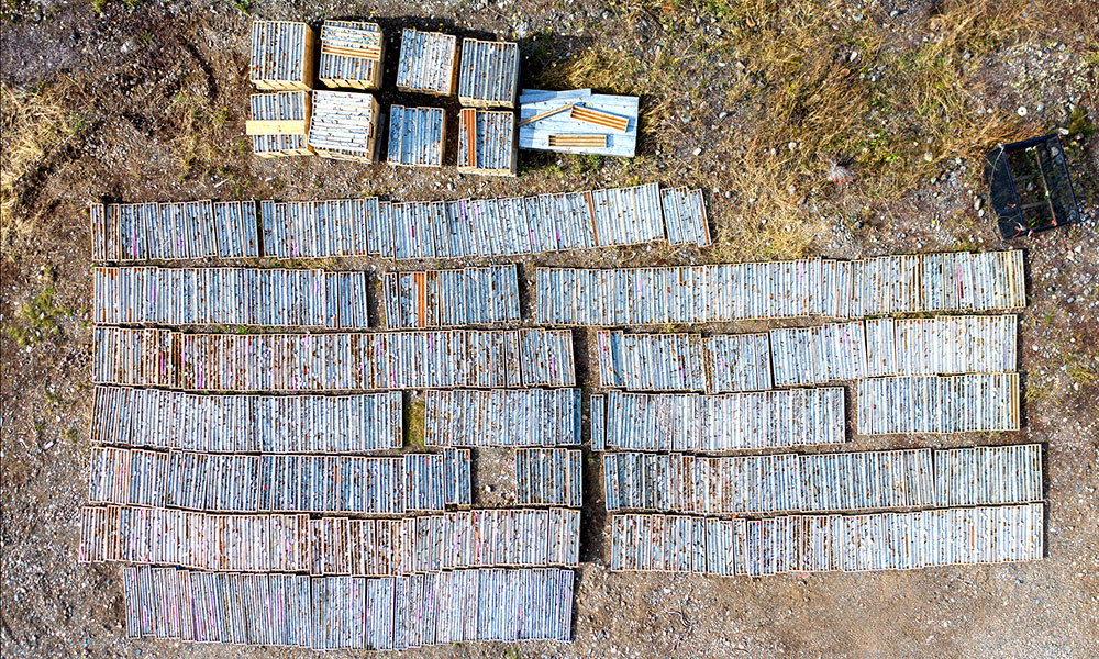 Drill core mineralized with gold and copper are laid out on the ground for a “quick log” prior to being processed.