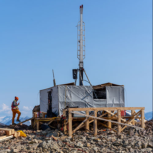 Cole Evans communicates by VHF radio as he inspects a diamond drill on a mountain top in BC’s famed Golden Triangle.